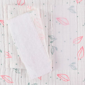 Cojín decorativo redondo en gasa de algodón modulable en protector de cuna o parque 