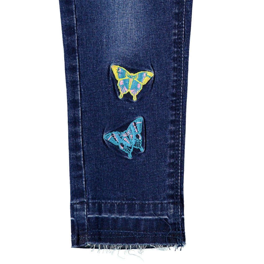 Vaqueros con efecto desgastado y arrugado con mariposas bordadas y cinturón brillante 