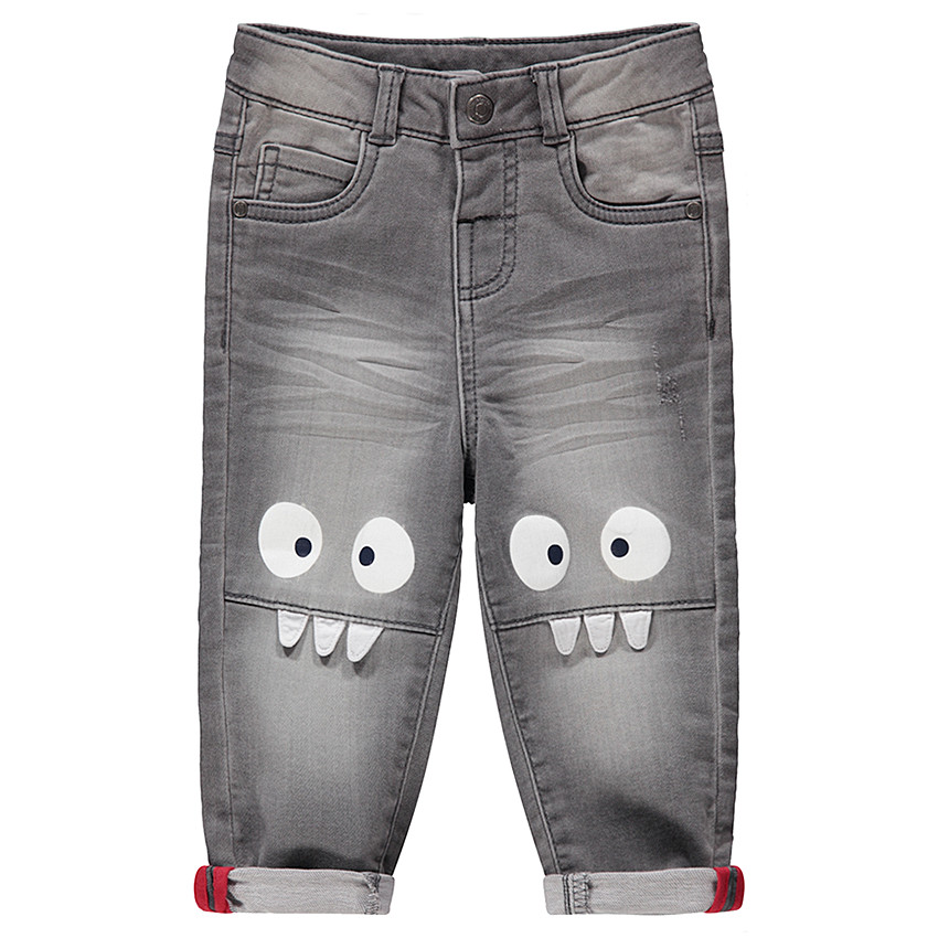 Vaqueros grises con efecto desgastado y arrugado con monstruos estampados en las rodillas 