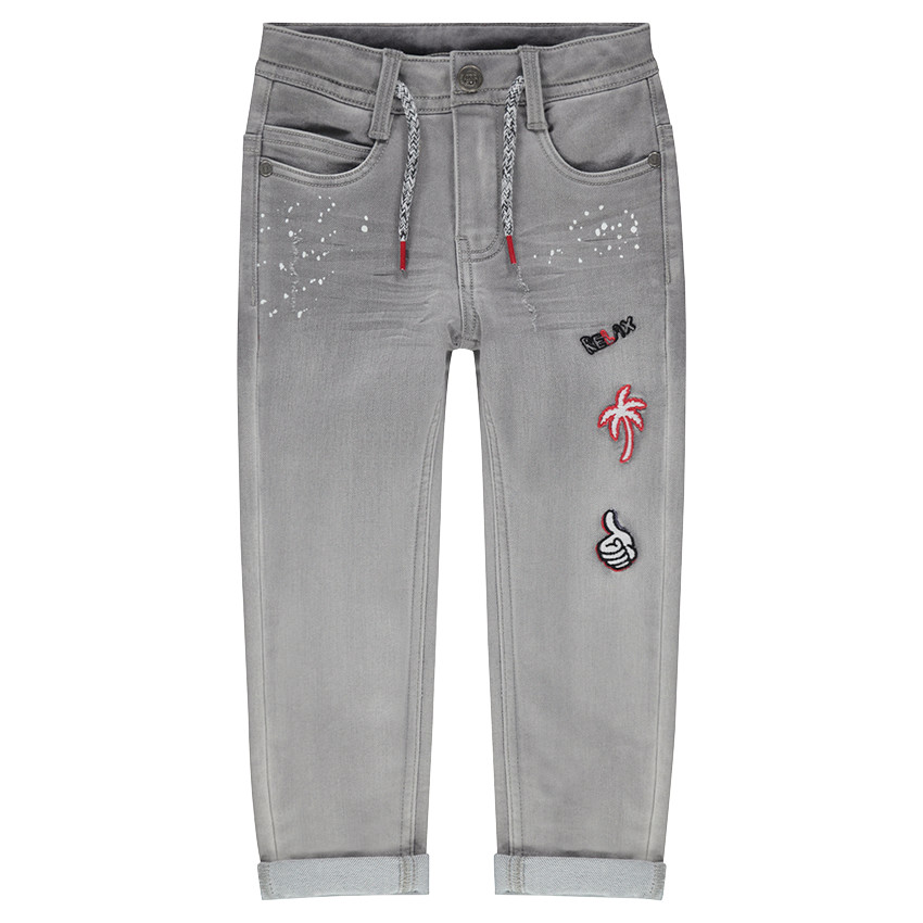 Vaqueros con efecto desgastado con manchas y parches cosidos 