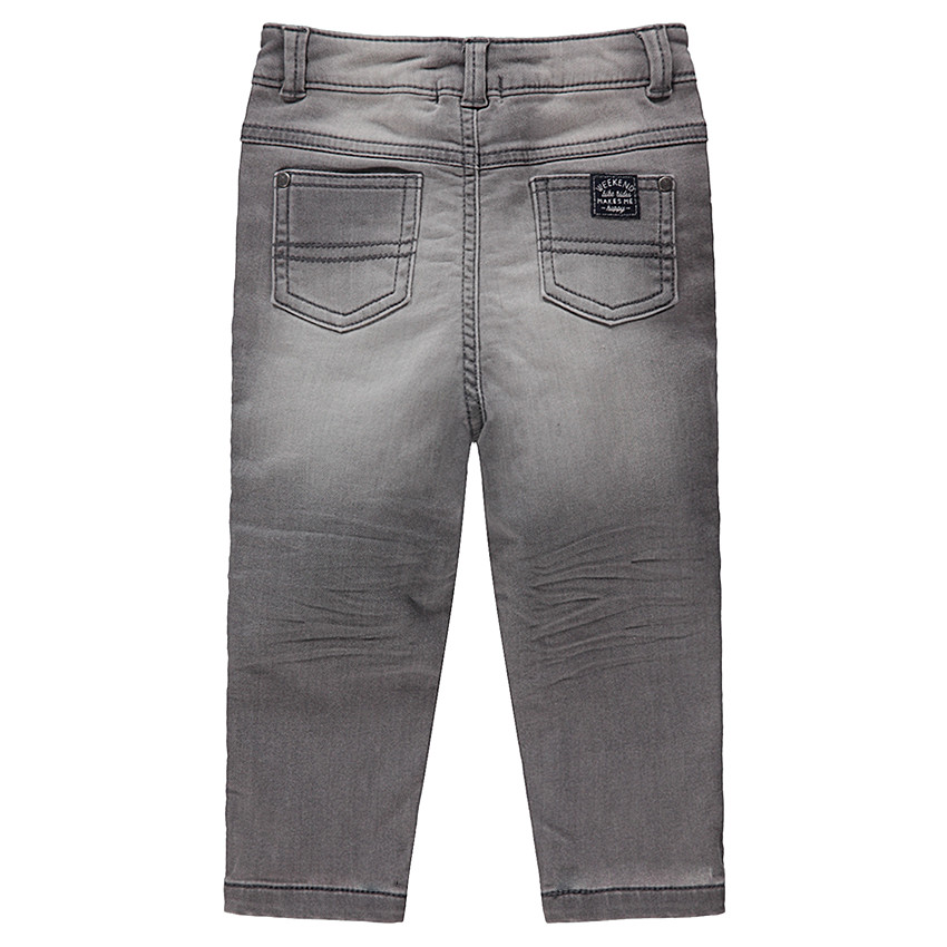 Vaqueros grises con efecto desgastado y arrugado con monstruos estampados en las rodillas 